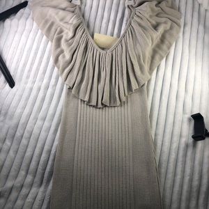 Nude colored tight fitting dress.